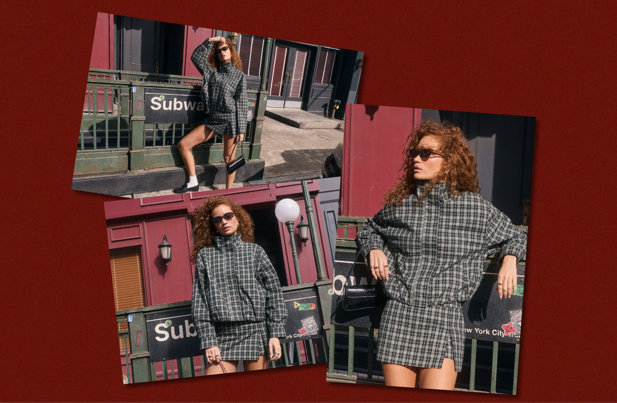Woman in a matching gray checkered blouse and skirt, sunglasses, and white sneakers.