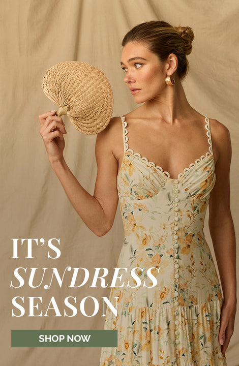 Woman in a floral sundress holding a straw fan, with text 