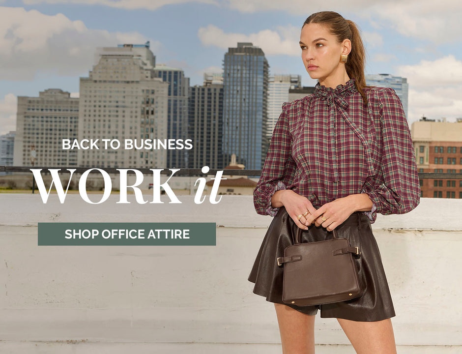 Woman in a plaid blouse with puffed sleeves and a high collar, and a leather skirt.