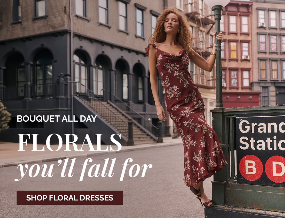 Woman in a long, floral burgundy dress with ruffled straps and a high-low hem.
