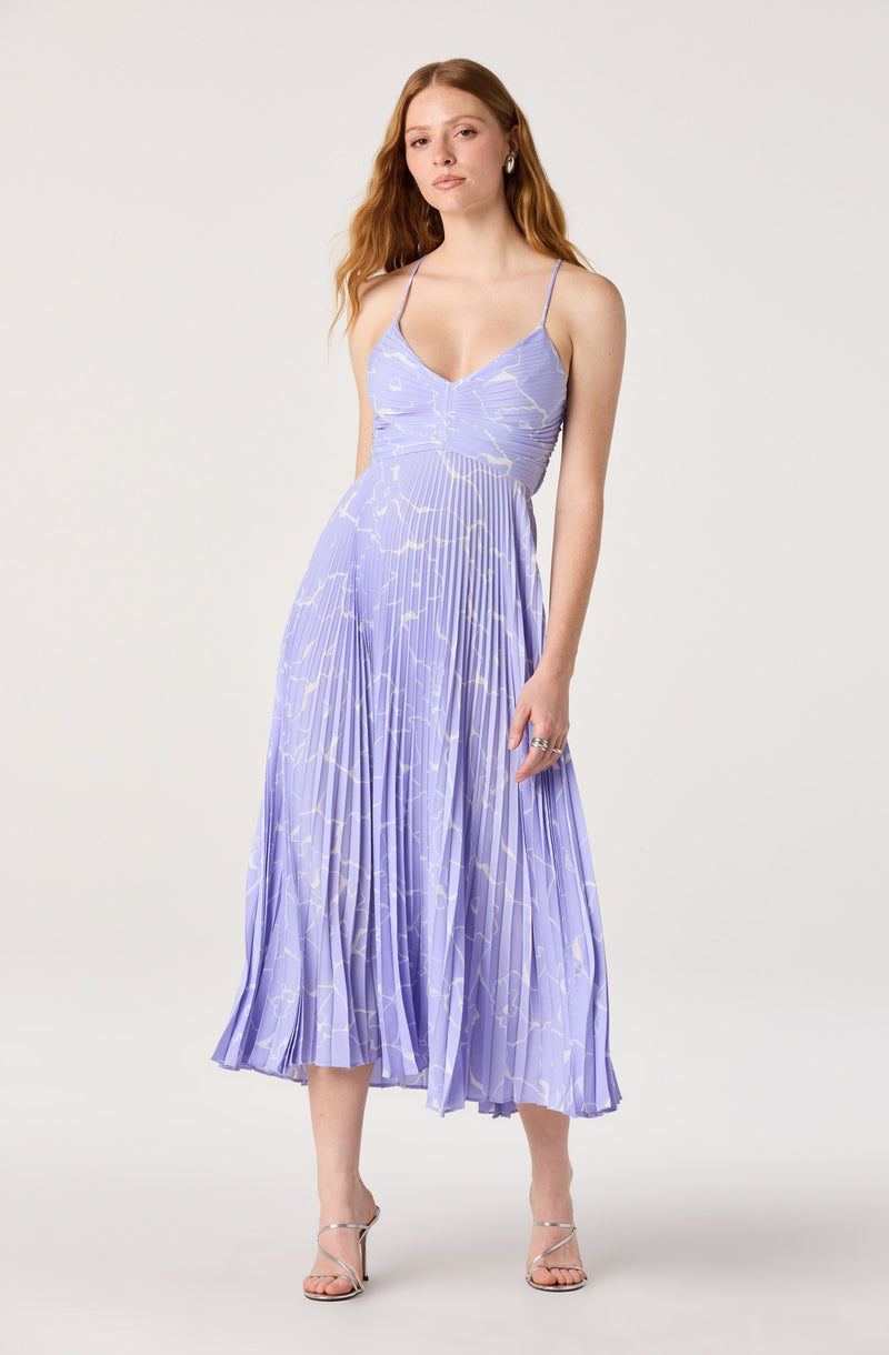 Lavender dress with thin straps, fitted bodice, and pleated, patterned skirt.