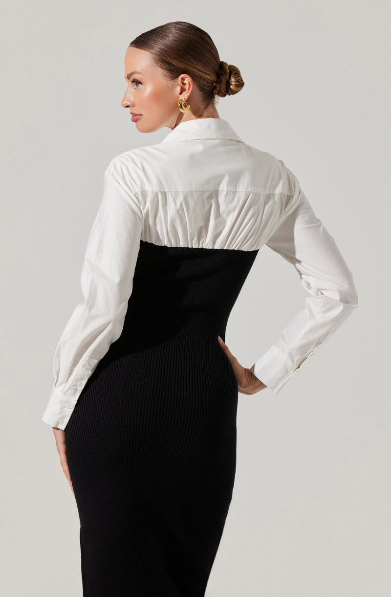 A woman is wearing a two-tone dress with a white, collared, long-sleeve top and a fitted, black, ribbed skirt that extends below the waist to a midi length.