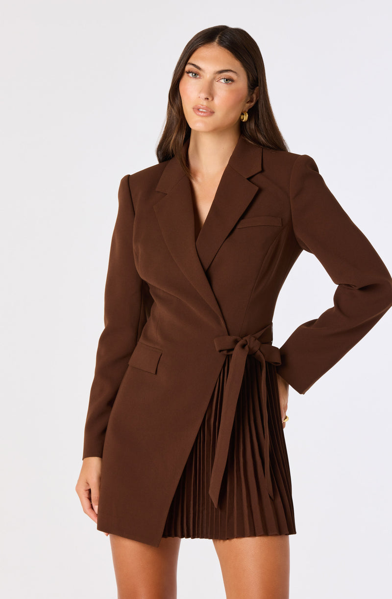 Brown blazer with a waist tie and a pleated skirt.