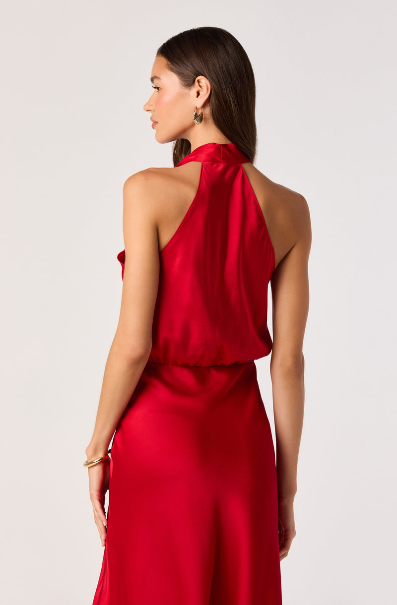 Woman in a sleeveless red satin dress with a high neckline.