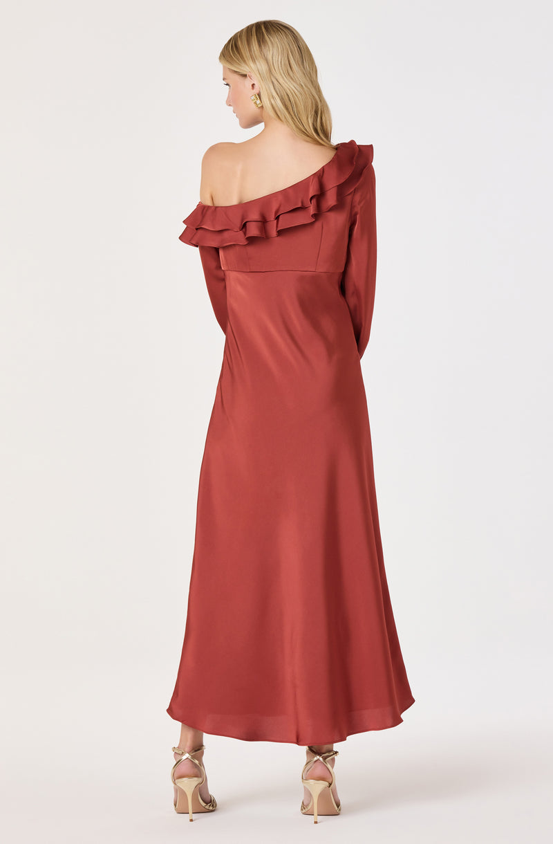 Woman in a rust-colored, off-the-shoulder satin dress with ruffled neckline and gold heels.