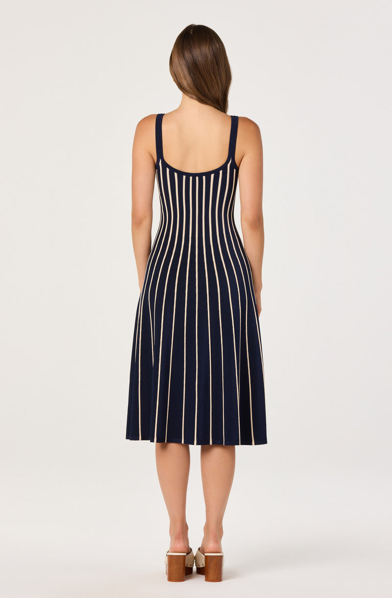 Navy dress with cream vertical stripes, sleeveless with thick straps, knee-length.
