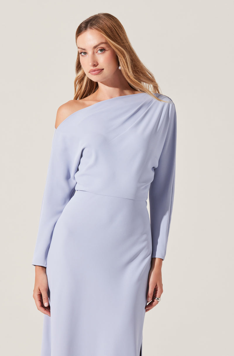 A woman is wearing a light blue, one-shoulder dress with long sleeves. The dress has a smooth, flowing fabric with a slight sheen, and it features a gathered detail on the shoulder. The waistline is fitted, creating a sleek silhouette.