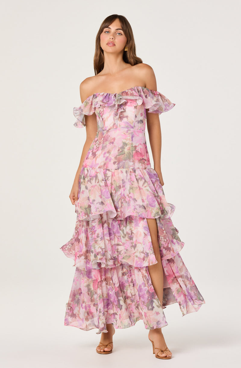 Off-the-shoulder pink floral dress with ruffled layers and a high slit.