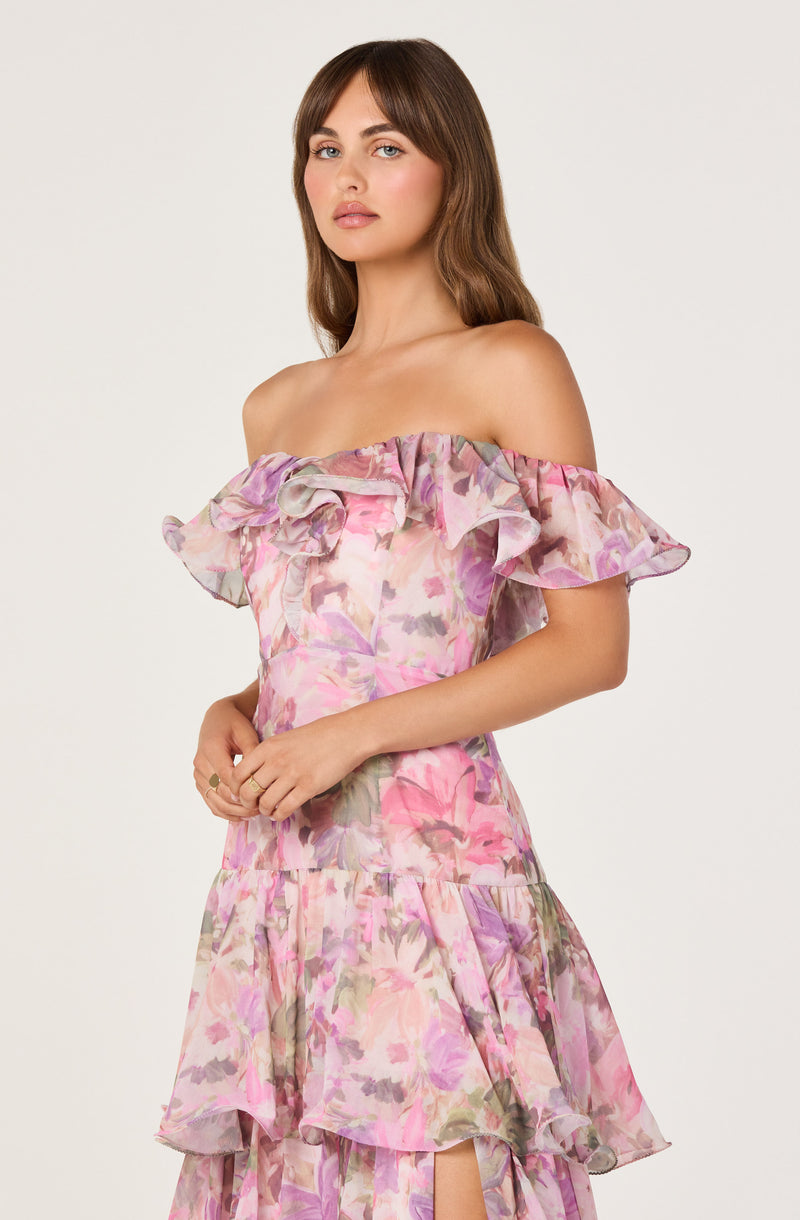 Off-the-shoulder dress with ruffled neckline and a layered, pink and purple floral pattern.