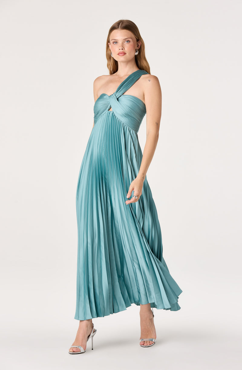 Woman wearing a teal pleated one-shoulder dress with a knot detail at the bust.