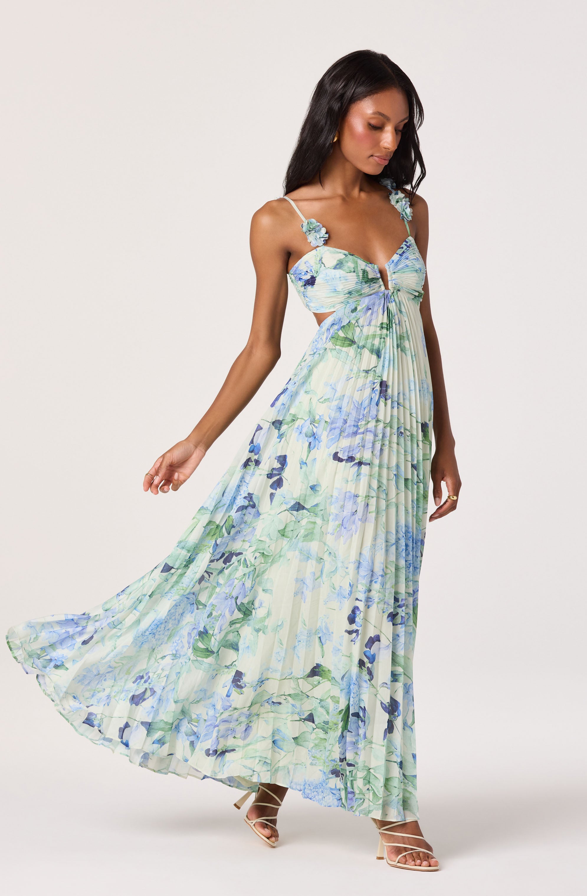 Sleeveless dress with floral print, cut-out bodice, and flowing maxi skirt.