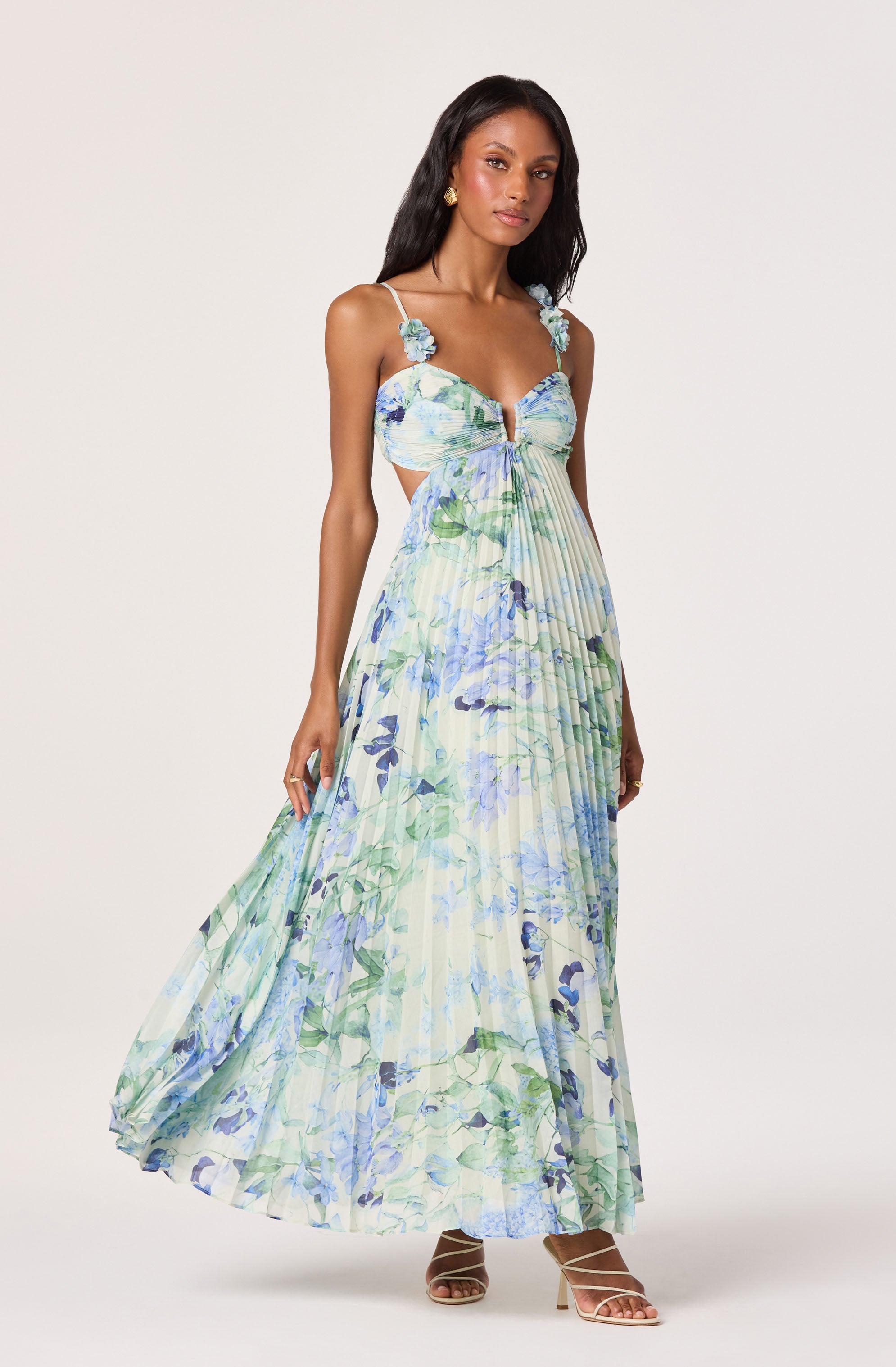 Long floral pleated maxi dress with spaghetti straps and 3D floral shoulder embellishments.