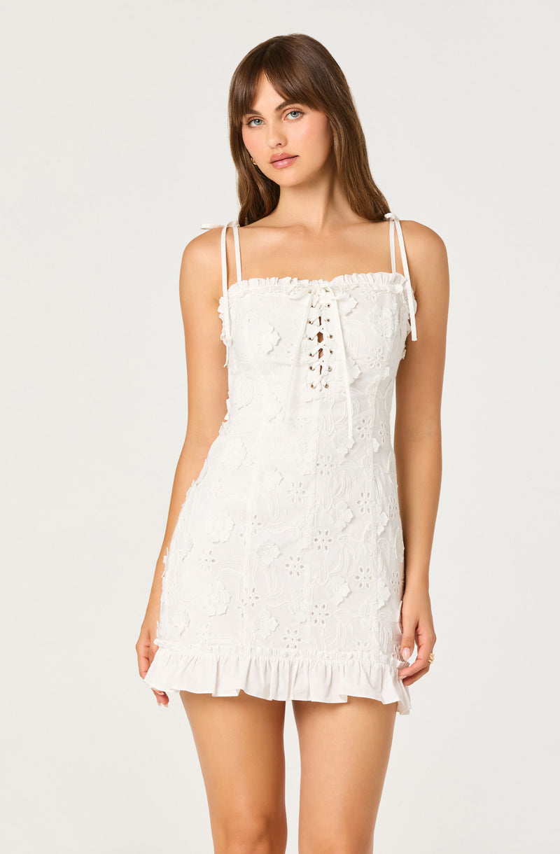 White eyelet lace summer dress with ruffled hem and spaghetti straps.