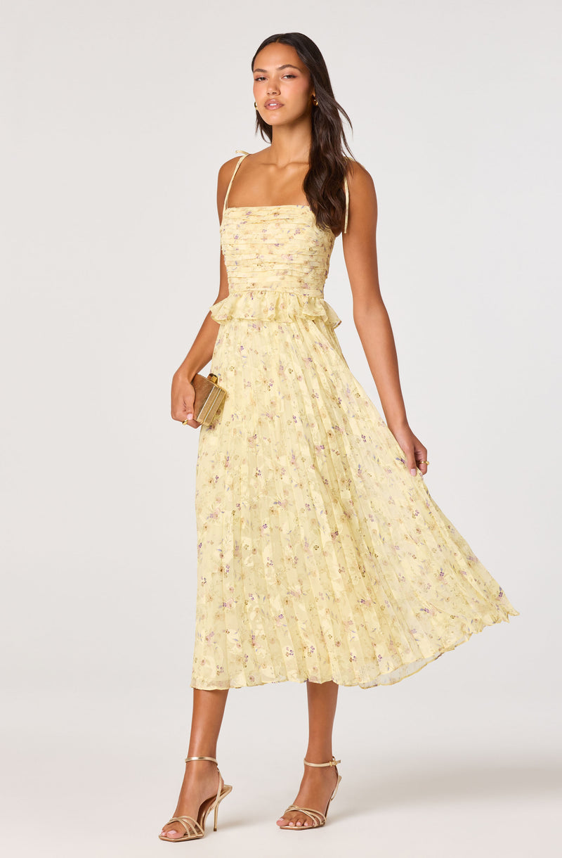 Yellow floral midi dress with spaghetti straps and ruffled waist.
