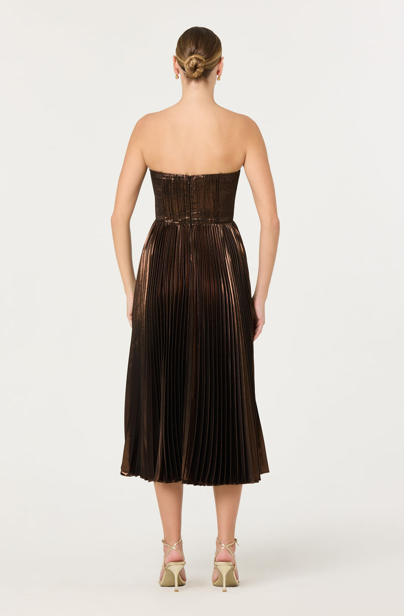 The dress is a strapless, metallic, pleated midi gown with a shiny bronze and black finish.