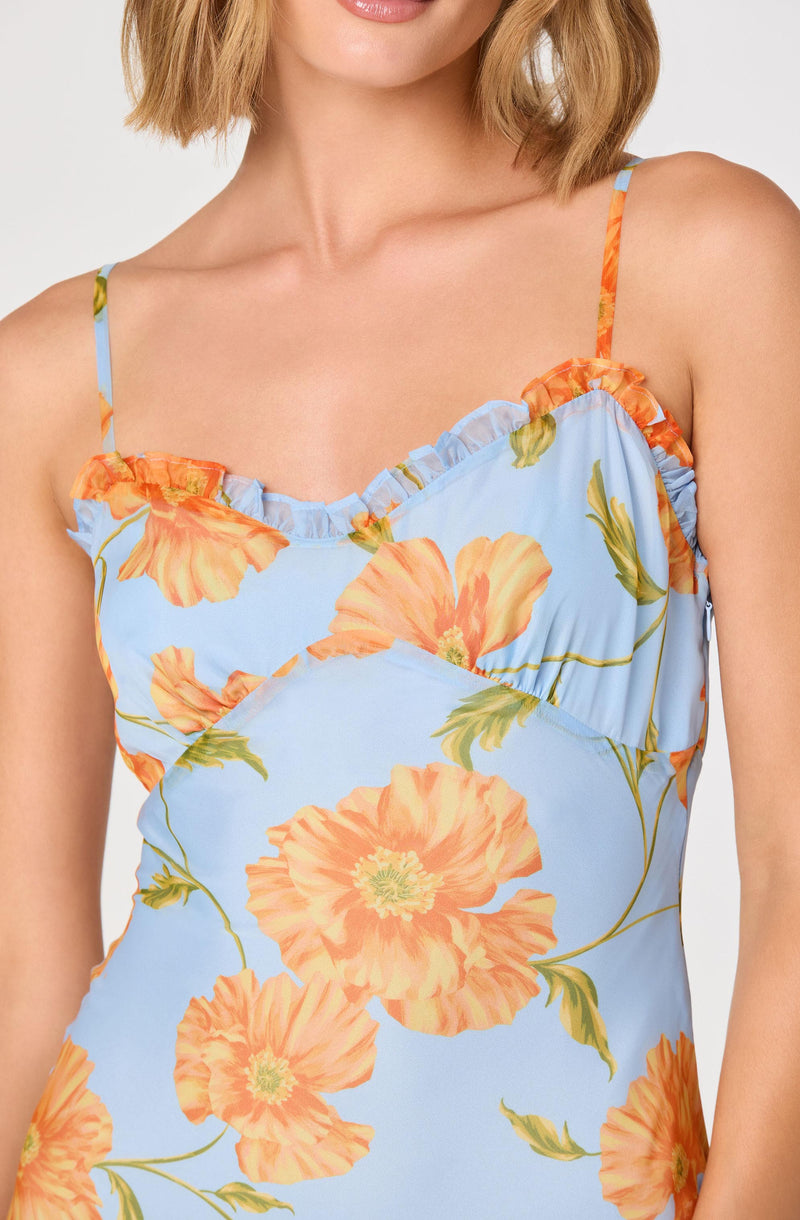 Light blue sundress with orange floral pattern and spaghetti straps.