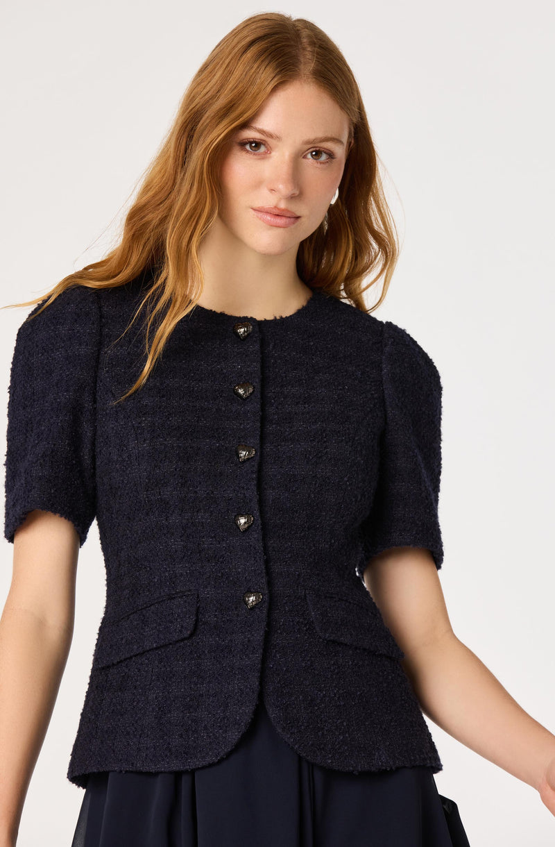 Navy textured short-sleeve jacket with pearl button details and front flap pockets.