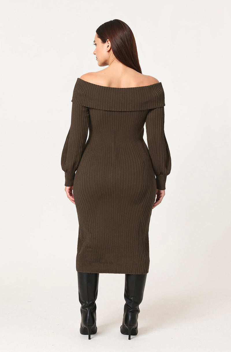 A woman is wearing a knee-length, ribbed, off-the-shoulder dress in an olive green color. The dress features a wide folded collar that drapes over her shoulders and long puffed sleeves that are fitted at the cuffs. She pairs the dress with black knee-high boots.
