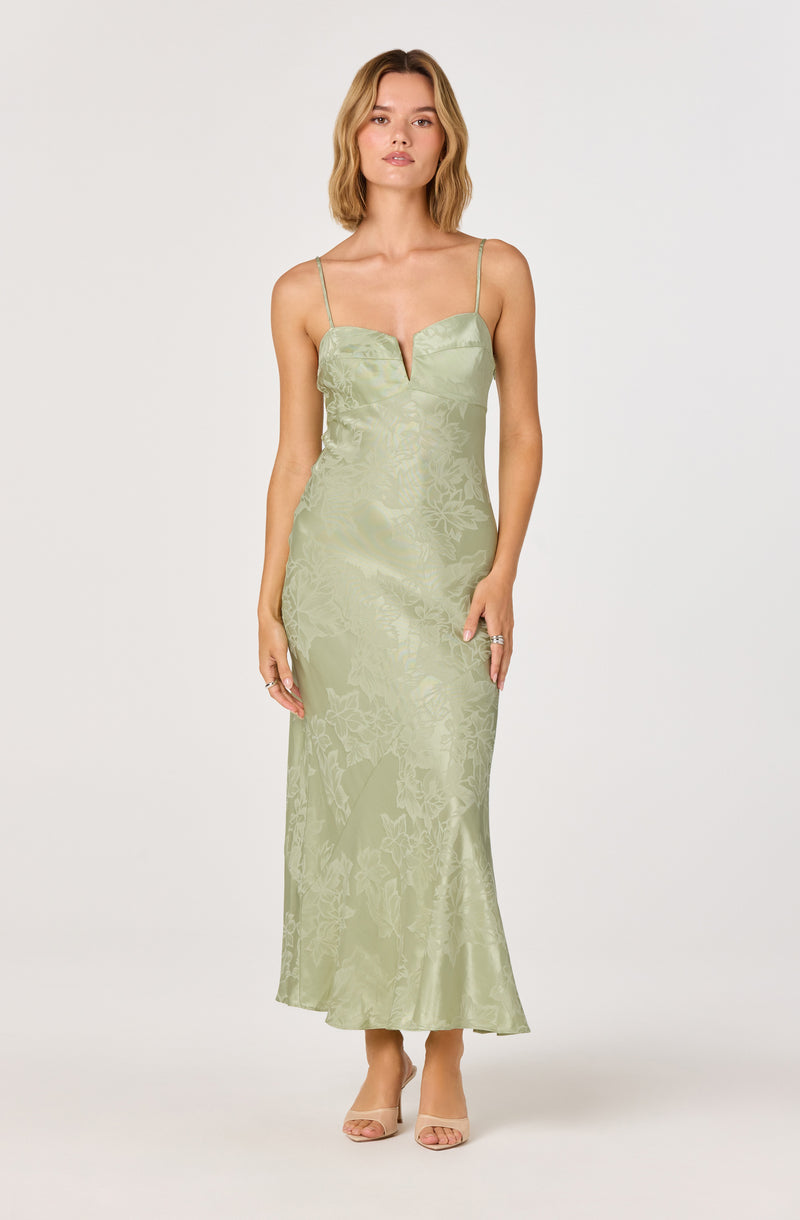 Light green satin evening gown with spaghetti straps and a deep V neckline.