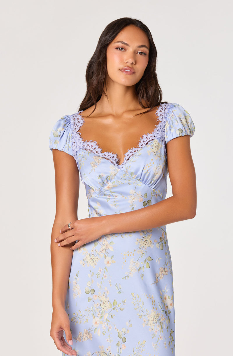 Light blue floral dress with lace accents on the neckline and puffed short sleeves.