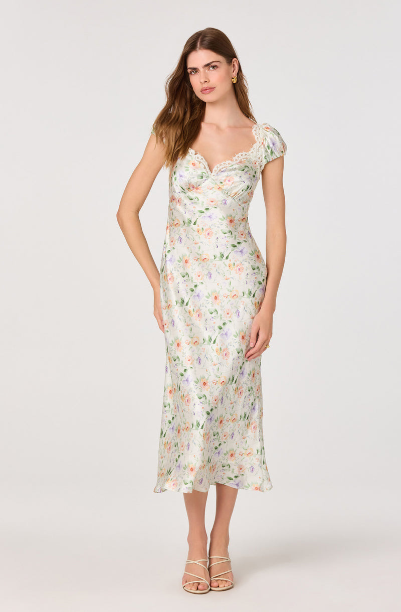 Long floral dress with lace details on the neckline and short sleeves.