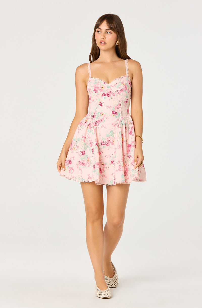 Pink floral dress with spaghetti straps and lace trim, paired with beige patterned heels.