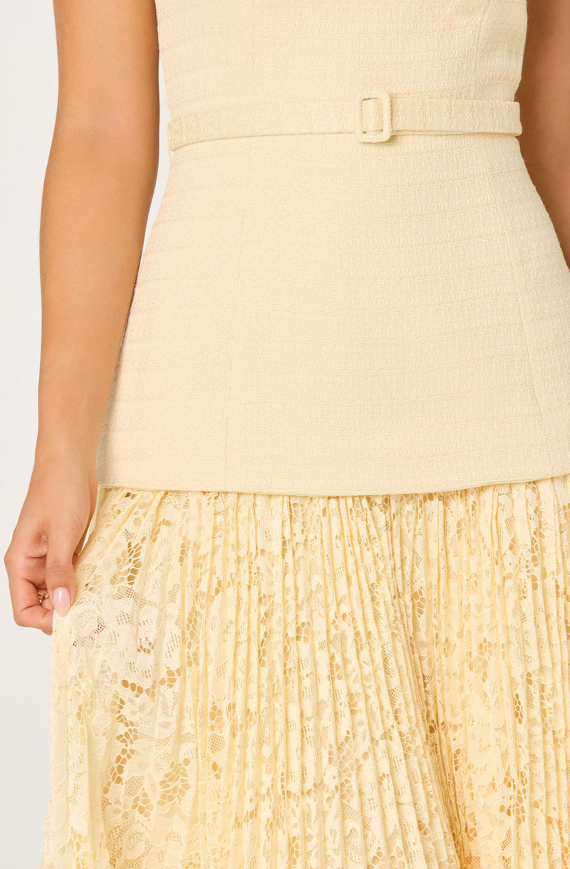 Light yellow dress with textured fabric top and lace pleated skirt.