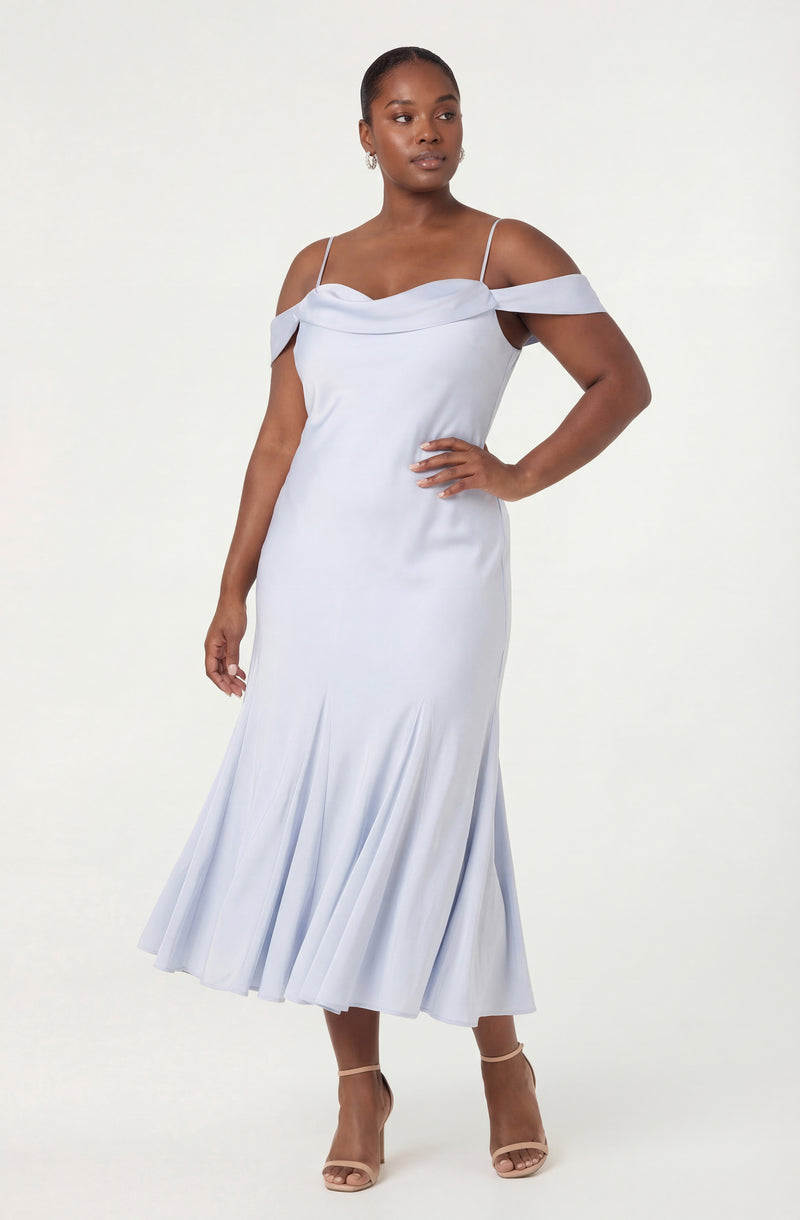 Woman in a light blue off-shoulder dress with pleated skirt and thin spaghetti straps.