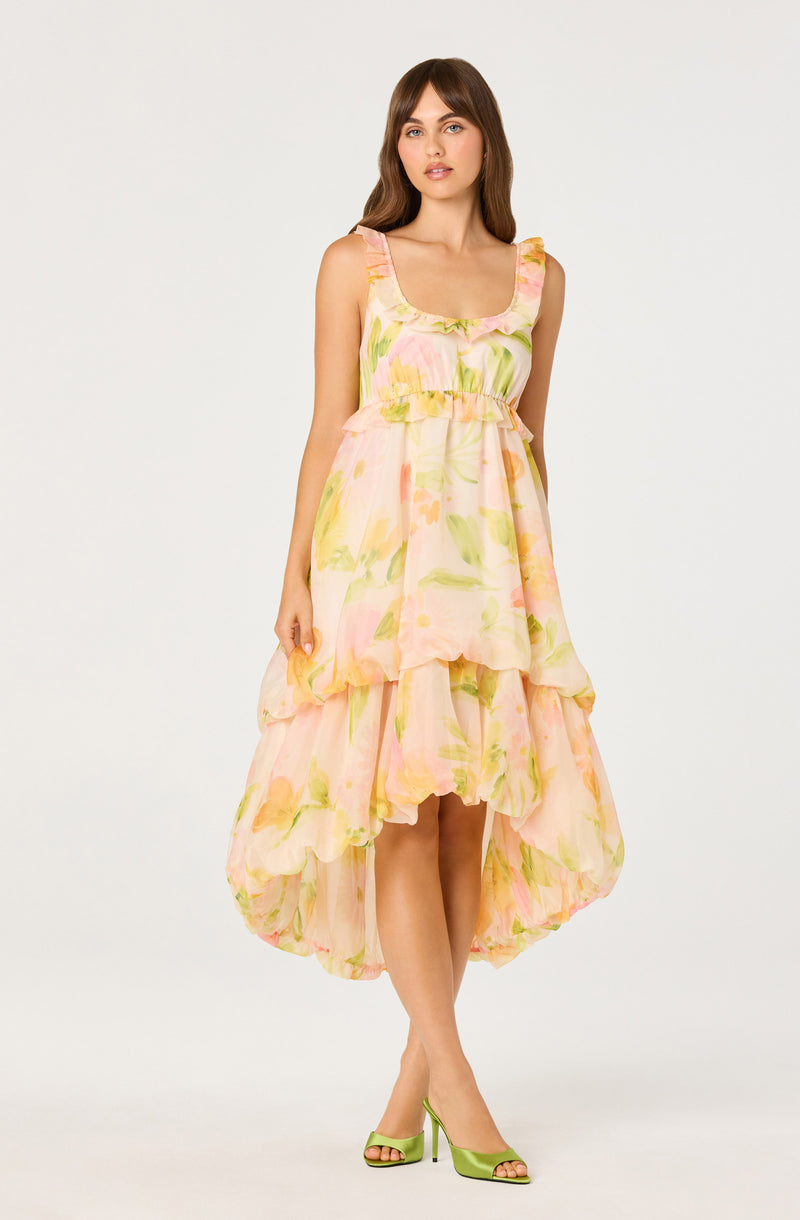 Sleeveless floral print dress with ruffled straps and high-low hemline, in pastel pink, green, and yellow.