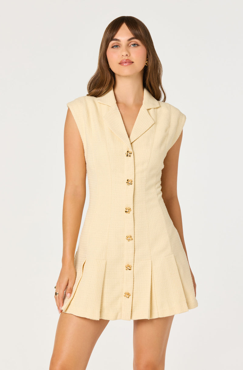Cream sleeveless dress with a notched collar and gold button details.