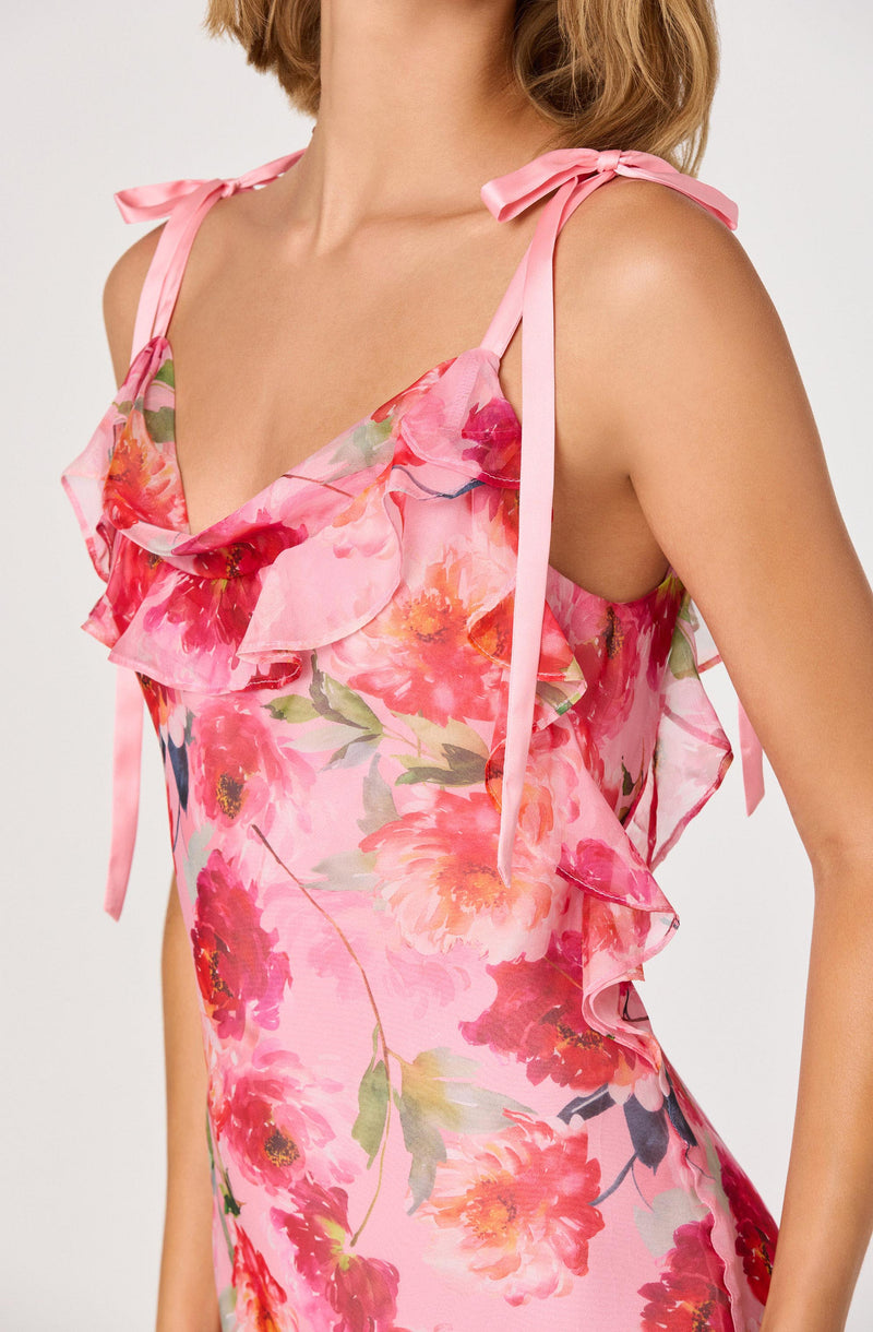 Pink floral dress with ruffled neckline and shoulder ties.