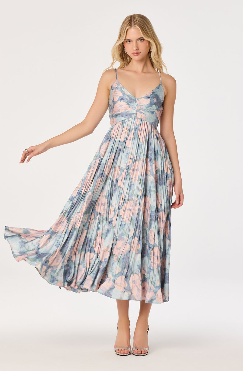 Sleeveless floral dress with spaghetti straps, fitted bodice, and flowing skirt.