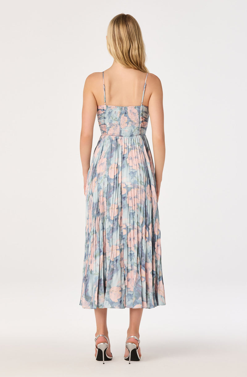 Maxi dress with a pastel floral pattern, smocked bodice, and thin spaghetti straps.