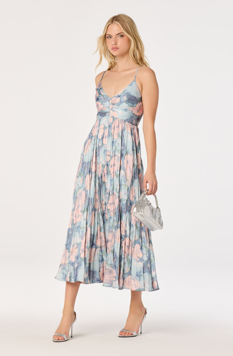 Spotted floral maxi dress with spaghetti straps, pleated skirt, and pastel colors.