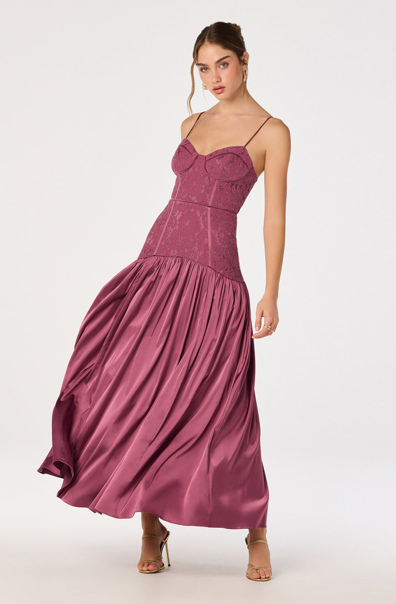 Young woman in a mauve lace and satin evening gown with spaghetti straps.