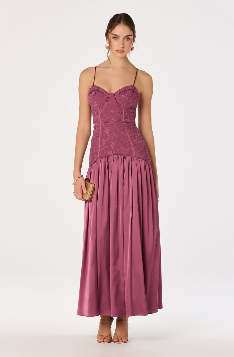 Girl in a sleeveless, strapless pink gown with lace bodice and pleated satin skirt.