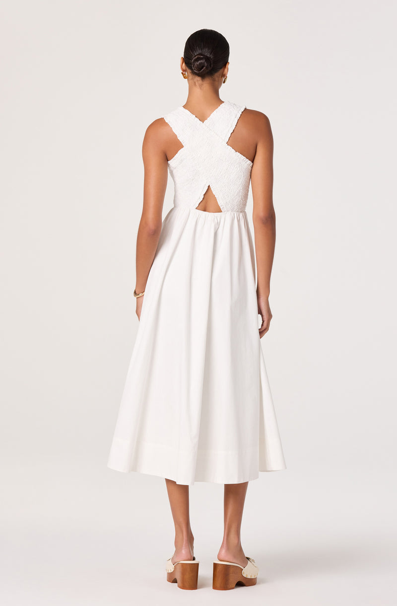 White dress with textured bodice, cut-out back detail, and full midi skirt.