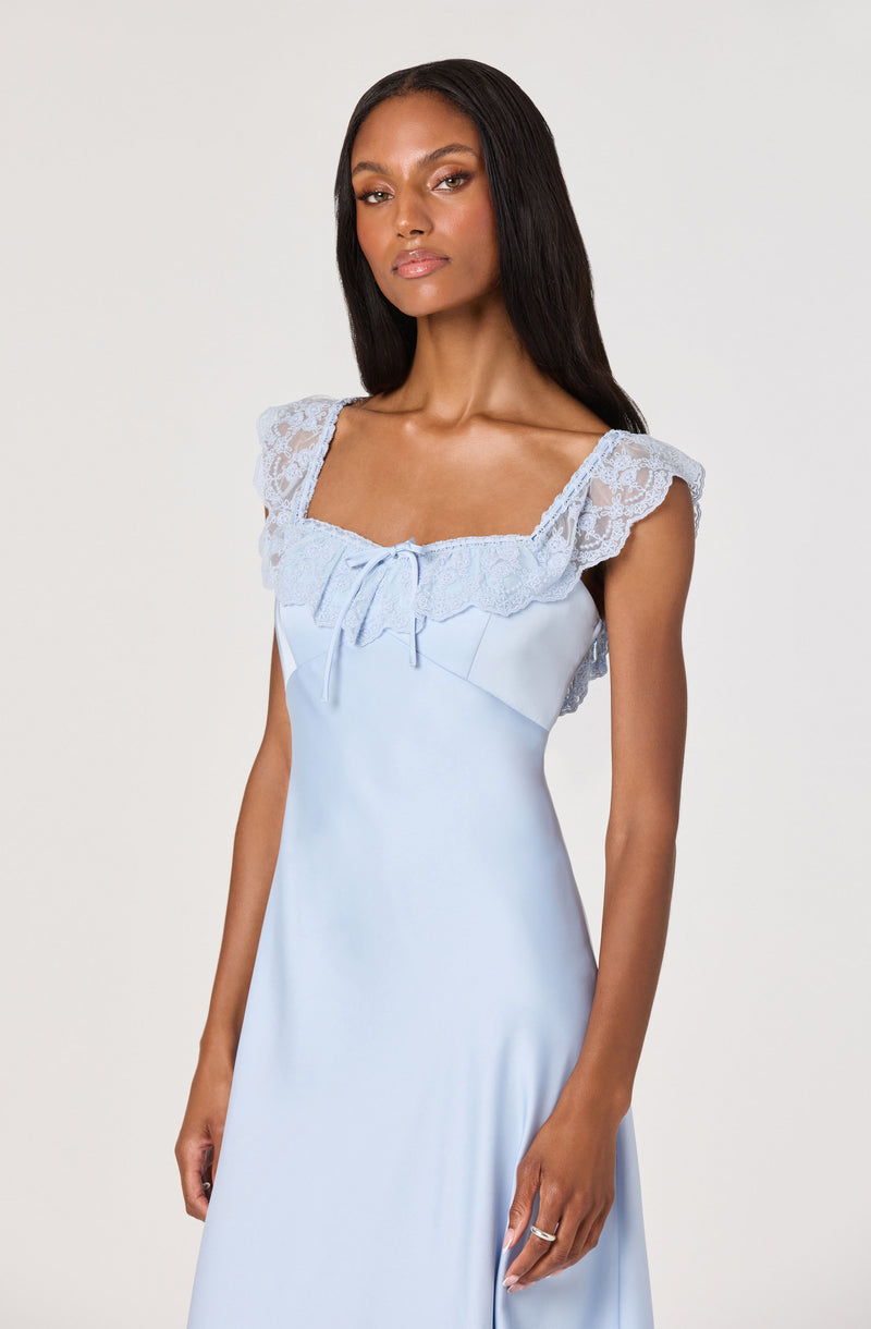 Light blue satin dress with lace shoulder straps and a bow at the neckline.