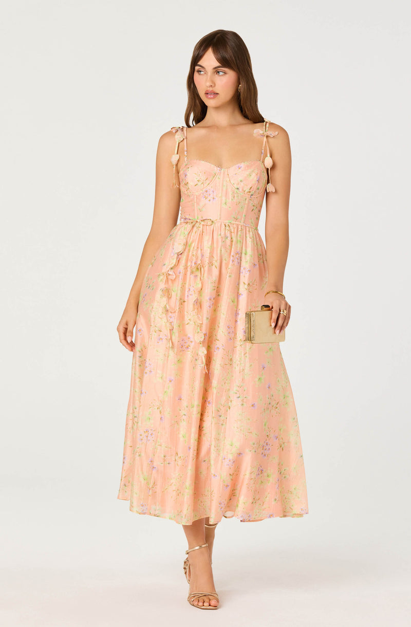 Light pink floral maxi dress with puffed shoulder straps and tied details.