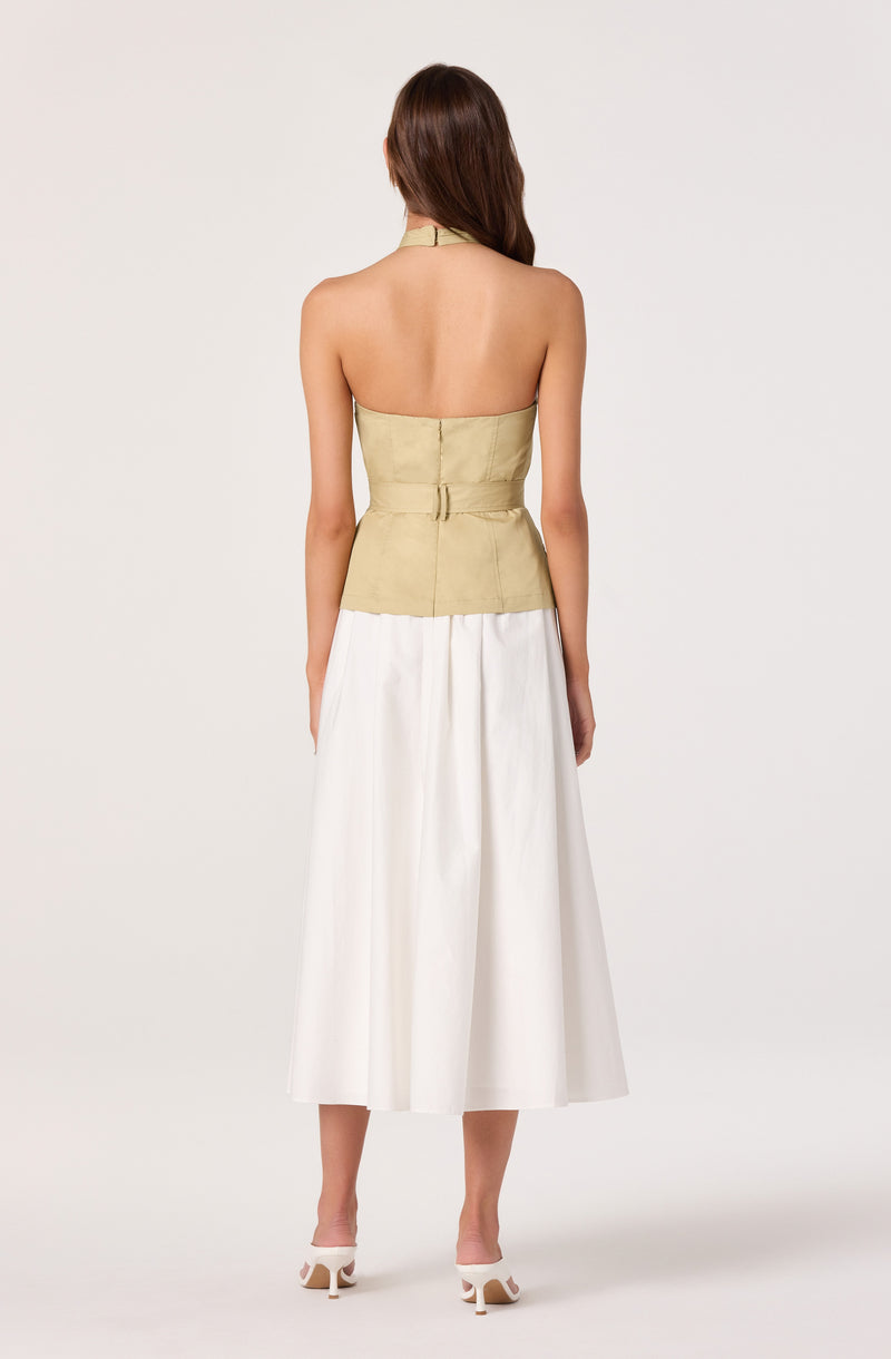 Back view of a woman wearing a strapless beige top, high waist, and white wide-leg midi skirt.