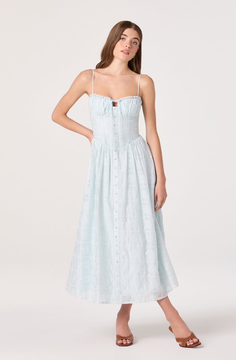 Light blue sundress with spaghetti straps, button-down front, and ruffled bodice.