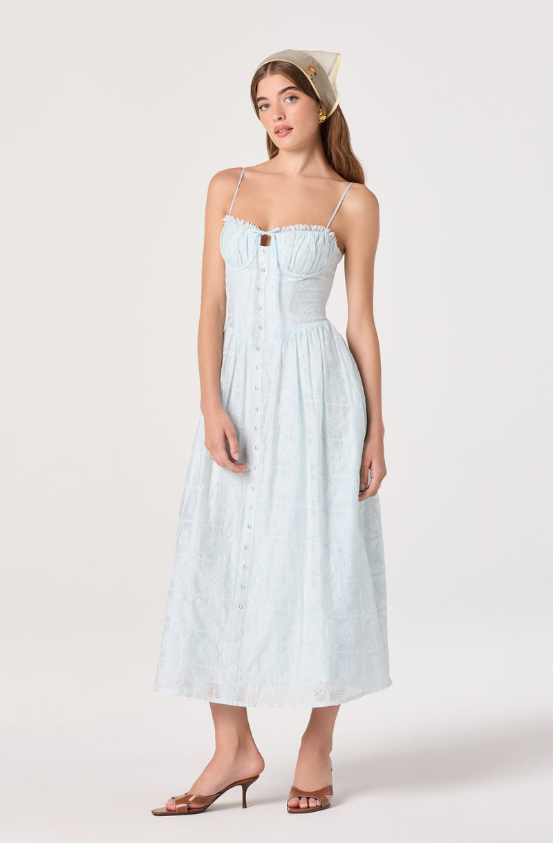 Light blue sleeveless dress with spaghetti straps, a fitted bodice, and button-down front.