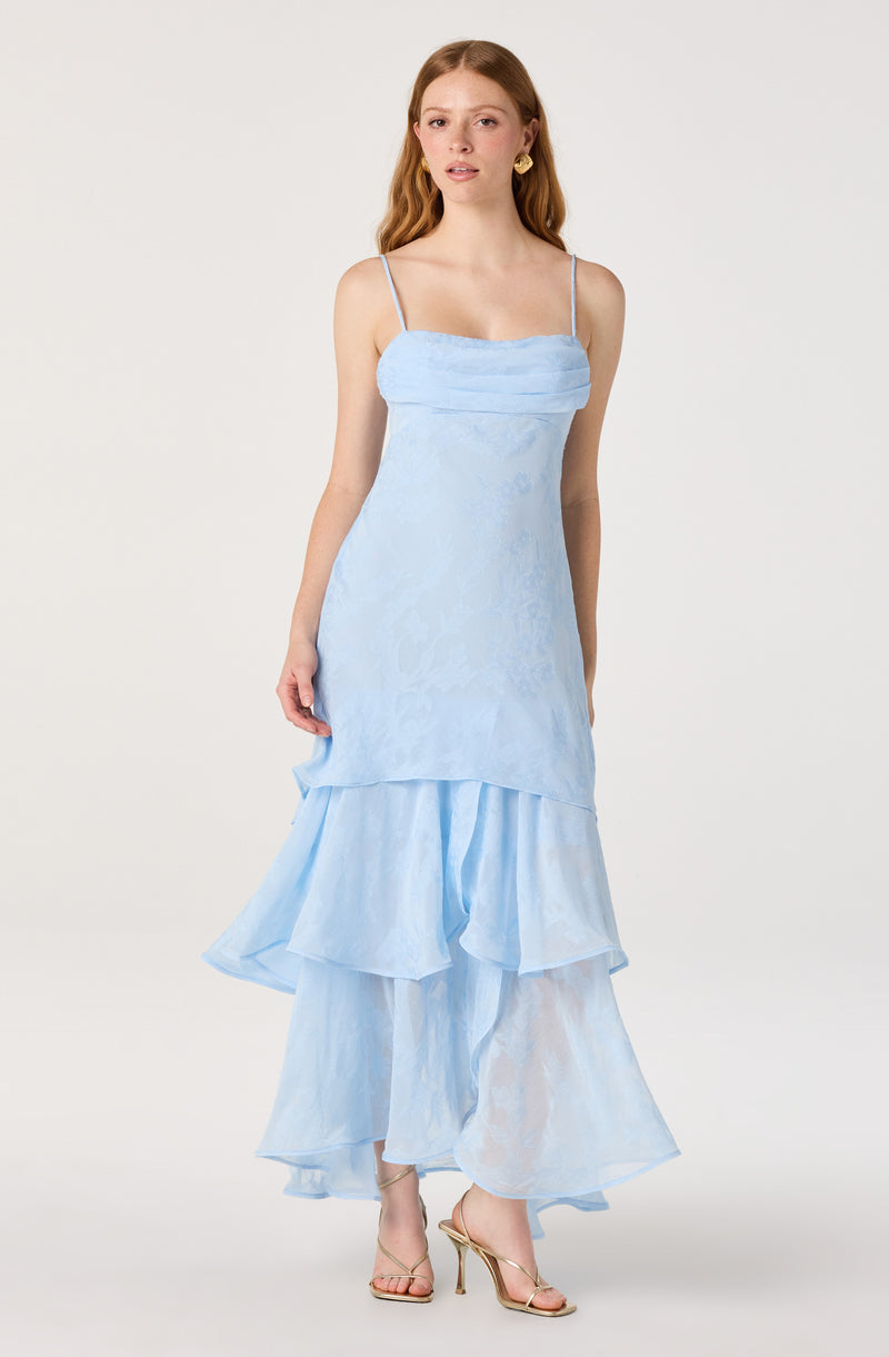 Light blue dress with thin spaghetti straps, layered ruffled skirt, and floral embroidered fabric.