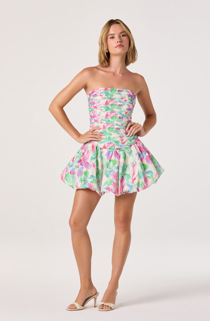 Strapless floral dress with a fitted bodice and a ruffled, voluminous skirt.