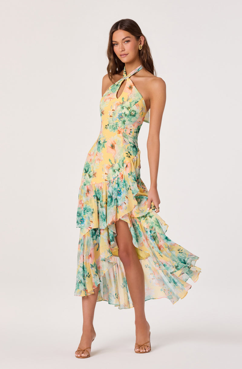 Light yellow floral halter dress with ruffled hem and asymmetrical high-low skirt.