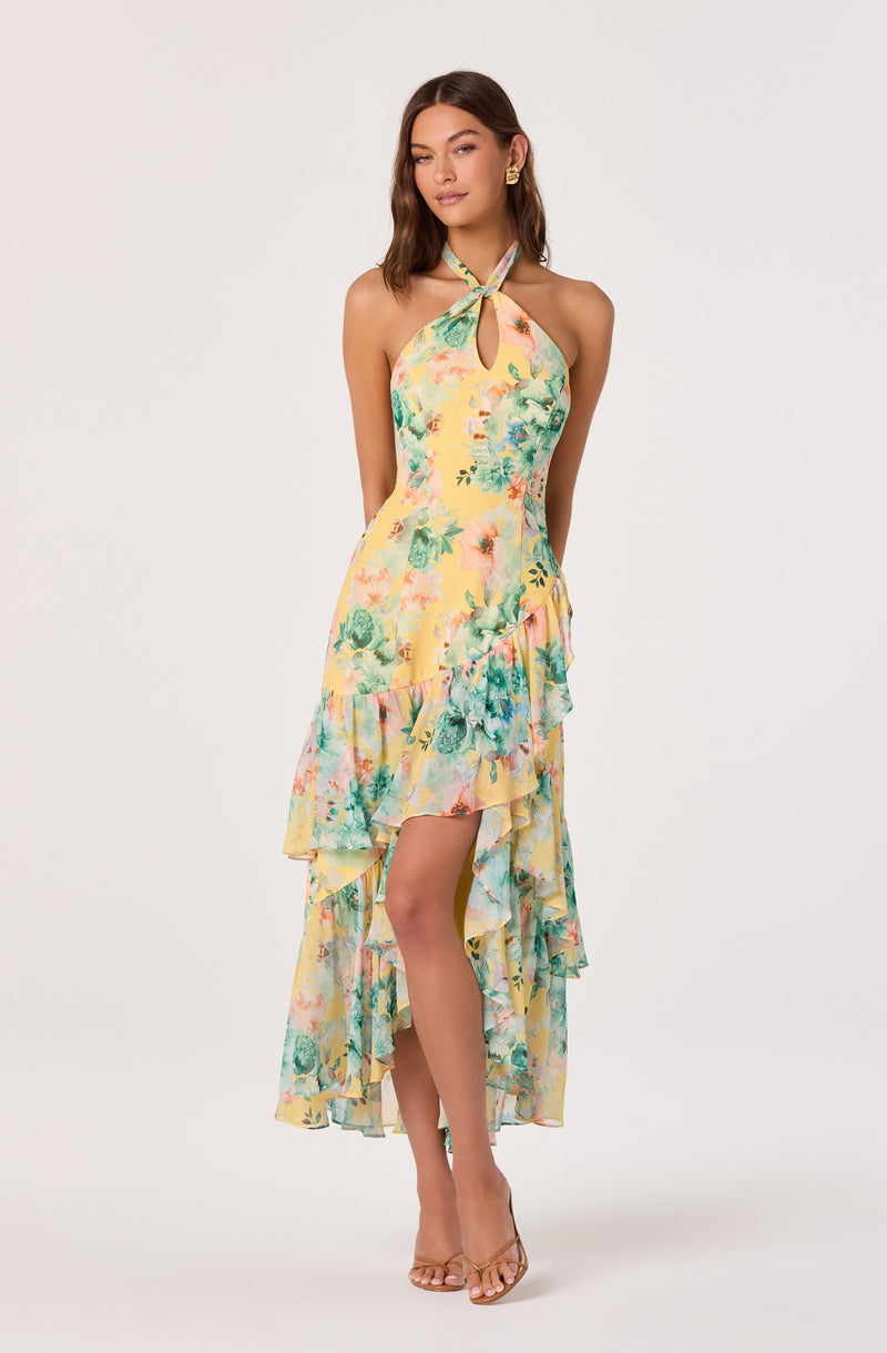 Yellow floral halter dress with ruffled high-low hemline and keyhole neckline.