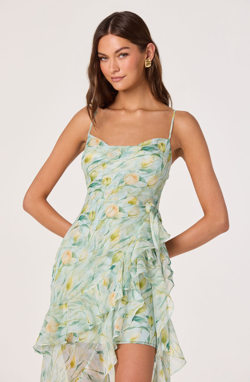 Light green floral dress with thin straps, ruffled overlay, and a wrap-style design.