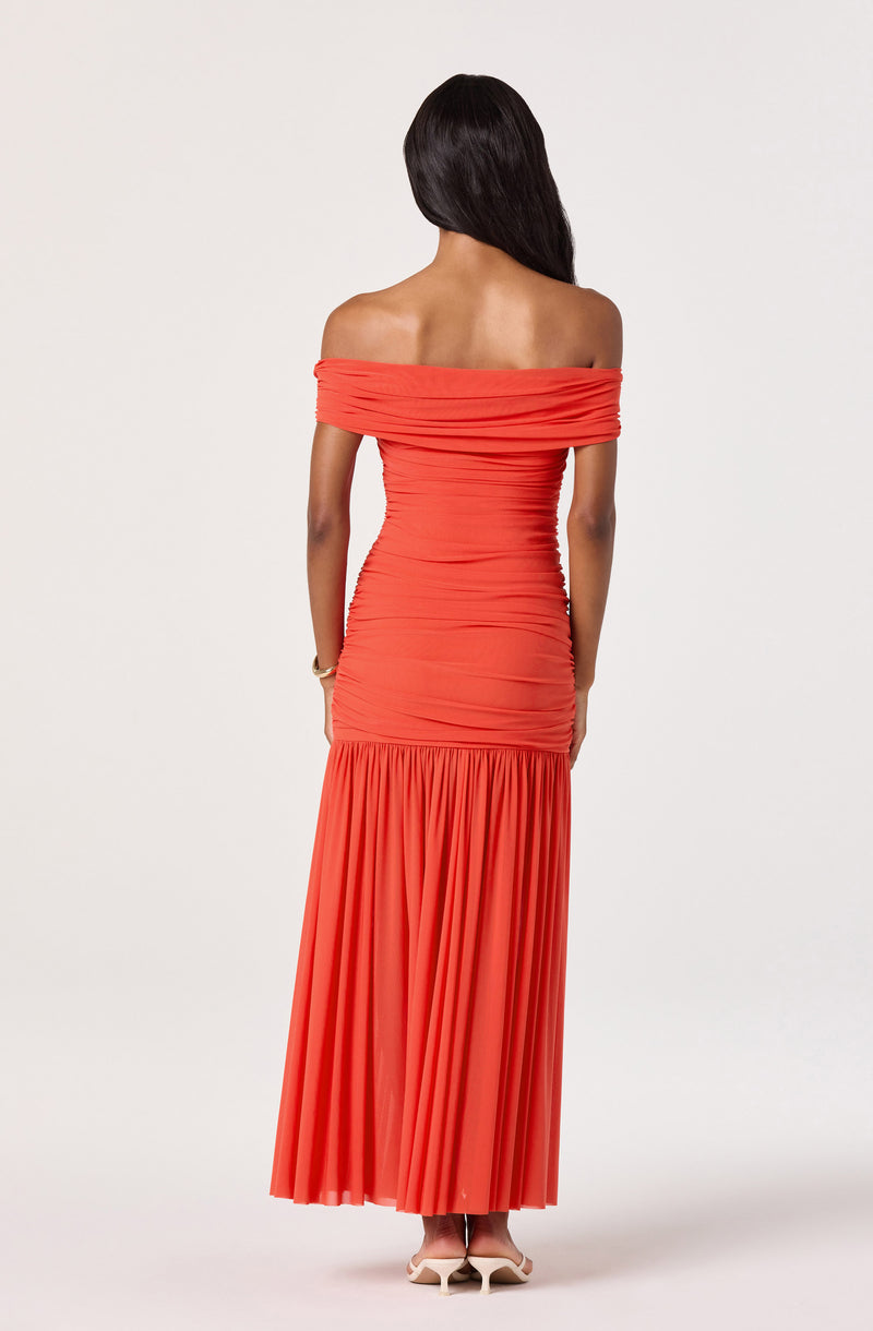 Off-the-shoulder coral dress with ruched bodice and pleated floor-length skirt.