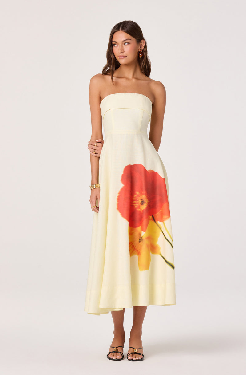 Strapless cream dress with a large red and yellow floral print at the bottom.