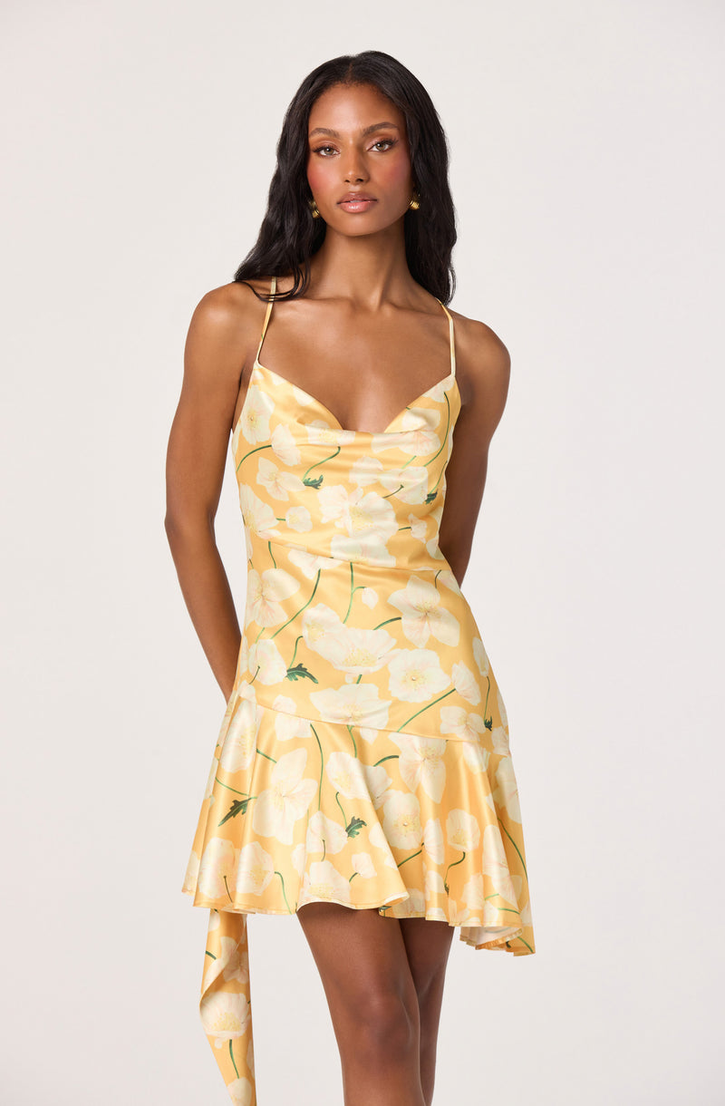 Yellow silk dress with floral print, spaghetti straps, cowl neckline, and ruffled hem.